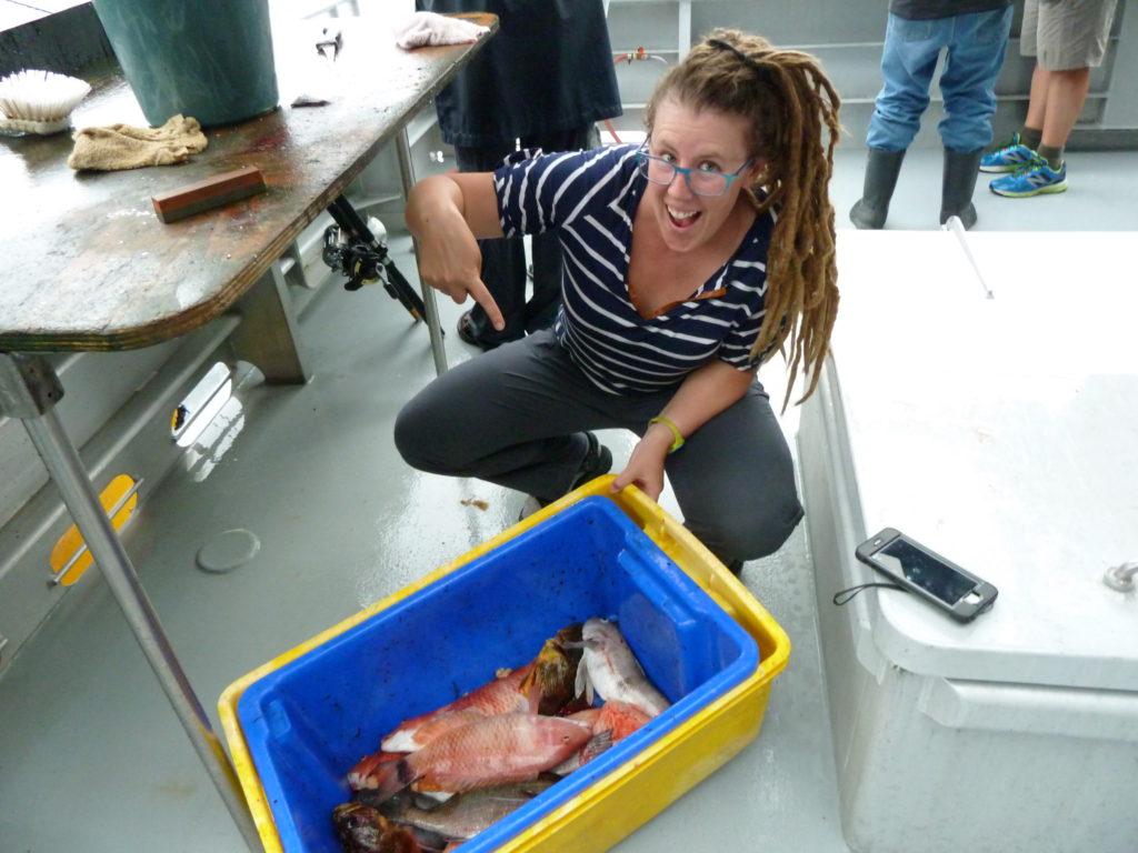 girl showing off fish catch