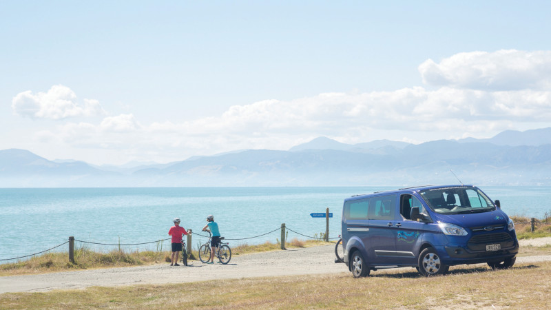 people on bikes looking at water